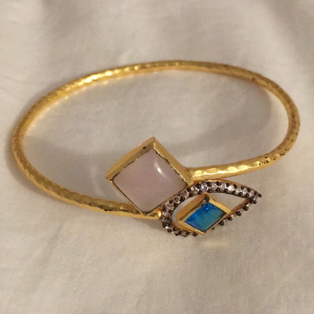 Gold bracelet with blue and pink stone finishes